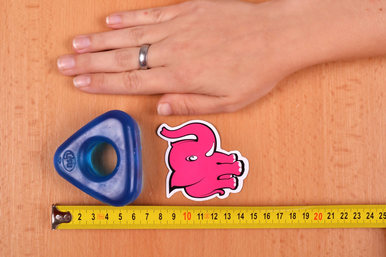 Erekčný krúžok Triangle Ring, vedľa ruky a metra erekčný krúžok Triangle Ring, rozmery - tmavo modrá